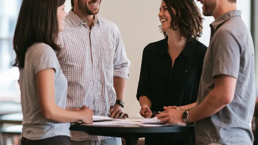 Warm portrait of the service team greeting visitors in a bright office lobby