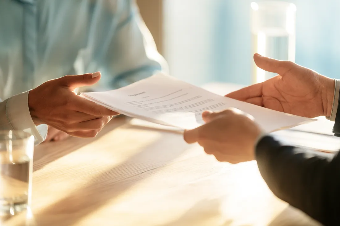 Signed starter personal loan agreement changing hands at a desk